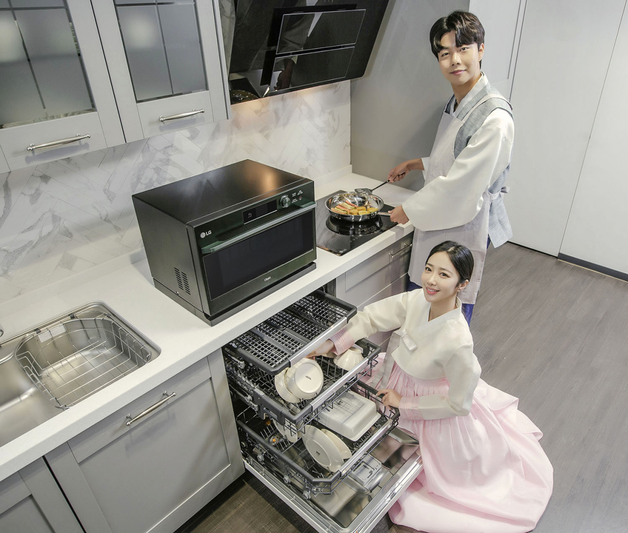 LG전자 소속 모델이 자사의 주방 가전에 대해 소개하고 있다. 사진 중앙은 ‘LG 디오스 광파오븐’, 오른쪽은 ‘LG 디오스 전기레인지’, 아래쪽은 ‘LG 디오스 식기세척기 스팀’. [LG전자 제공]