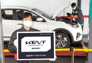 기아 오토큐 정비 엔지니어가 ‘KEVT 베이직’ 인증 현판을 선보이고 있다. [기아 제공]