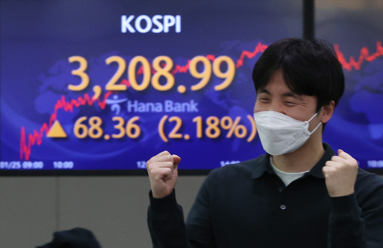 1월 증시에서 개인과 기관이 사상 최대규모의 순매수와 순매도로 정면충돌한 것으로 집계됐다. 코스피가 종가 기준 3200선을 처음 돌파한 지난 달 25일 오후 서울 중구 하나은행 딜링룸에서 직원이 환하게 웃는 모습.[사진=연합뉴스]