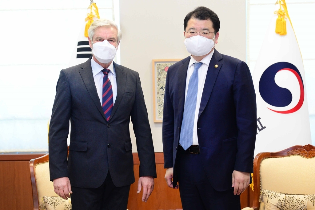 First Vice Foreign Minister Choi Jong-kun (R) and German Ambassador to South Korea Michael Reiffenstuel pose for a photo as they meet for talks at the foreign ministry in Seoul on Feb. 4, 2021, in this photo provided by the ministry. (Yonhap)