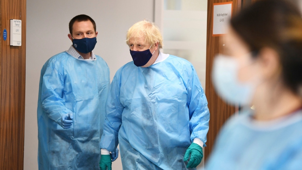 Britain's Prime Minister Boris Johnson tours the Lighthouse Laboratory, used for processing polymerase chain reaction (PCR) samples for coronavirus, during a visit to the Queen Elizabeth University Hospital campus in Glasgow on his one day visit to Scotland, Thursday, Jan. 28, 2021. (AP-Yonhap)