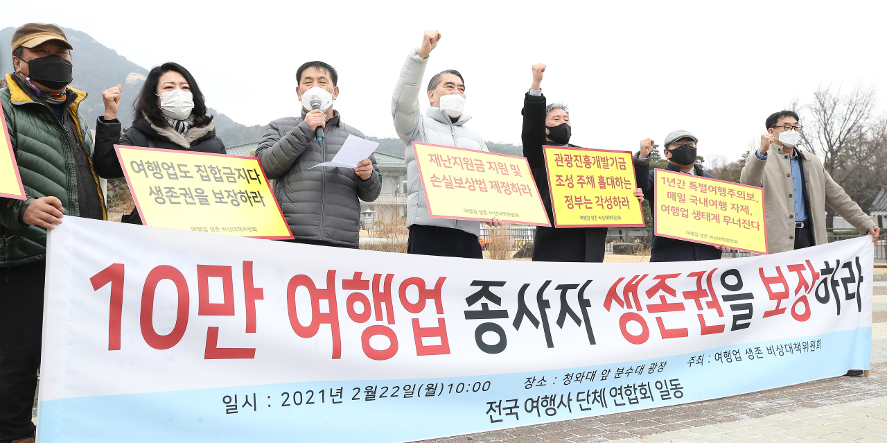 Travel agency workers demand for relief measures during a press conference they held near the Blue House on Monday.