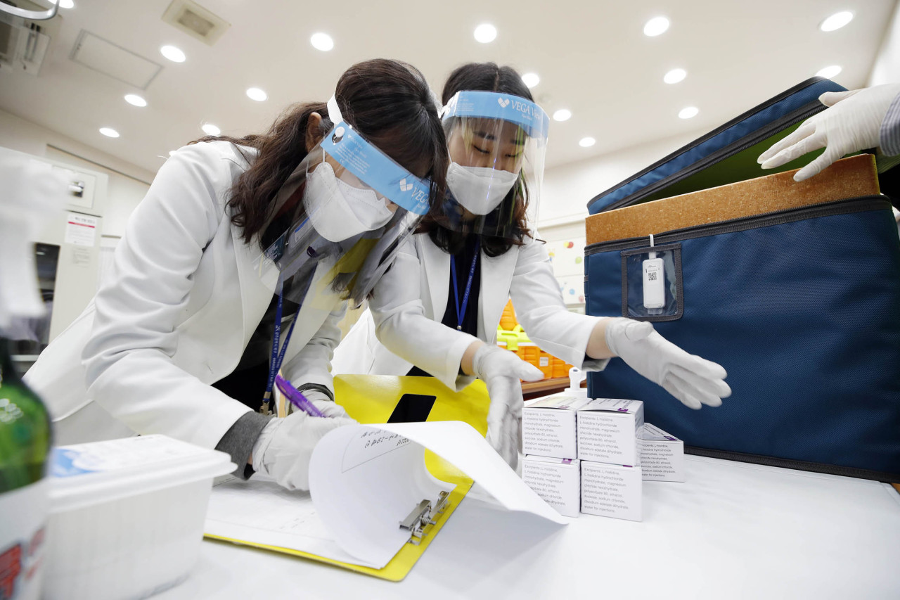 Public health center employees in Gwangju check the delivered batches of COVID-19 vaccines from AstraZeneca on Thursday. [Gwangju City Buk-gu]