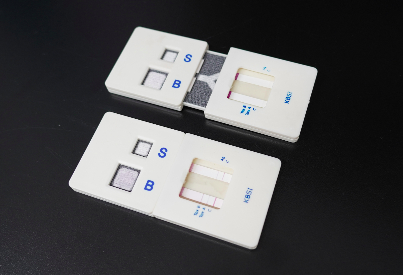 연구팀이 개발한 mPAD. 아래 키트는 실험 후 사진으로 항원 1종(GDH)과 독소 2종(Toxin A, B)이 검출됐음을 붉은 선을 통해 확인할 수 있다.[한국기초과학지원연구원 제공]