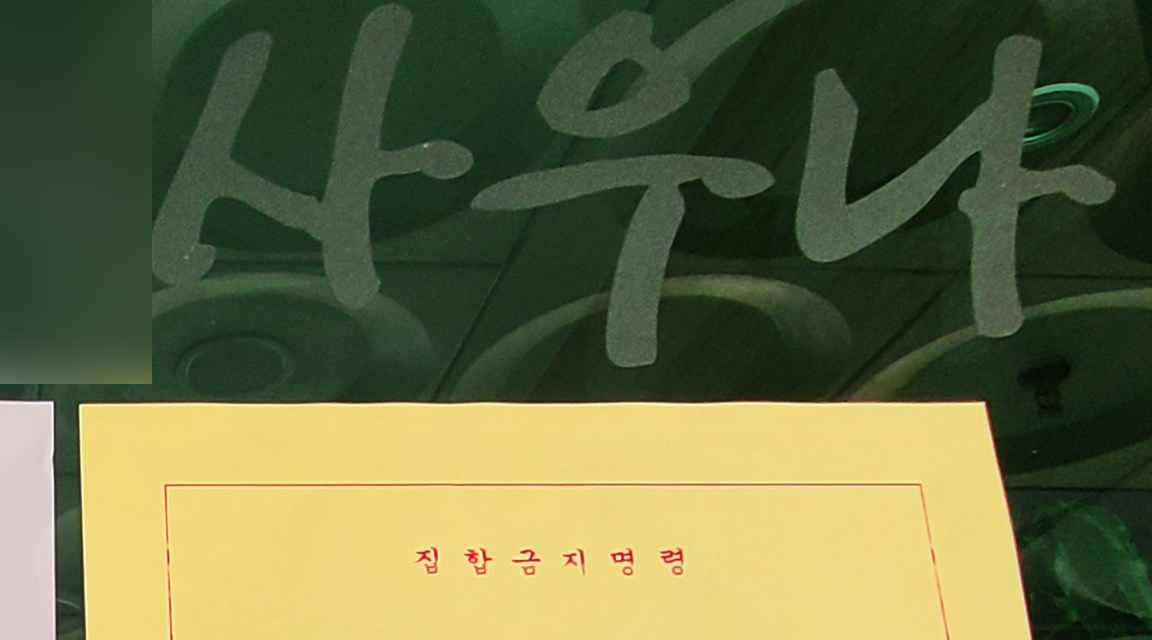 15일 집단감염이 속출하고 있는 경남 거제 한 사우나 문에 집합금지명령 공문이 붙어있다. [연합]