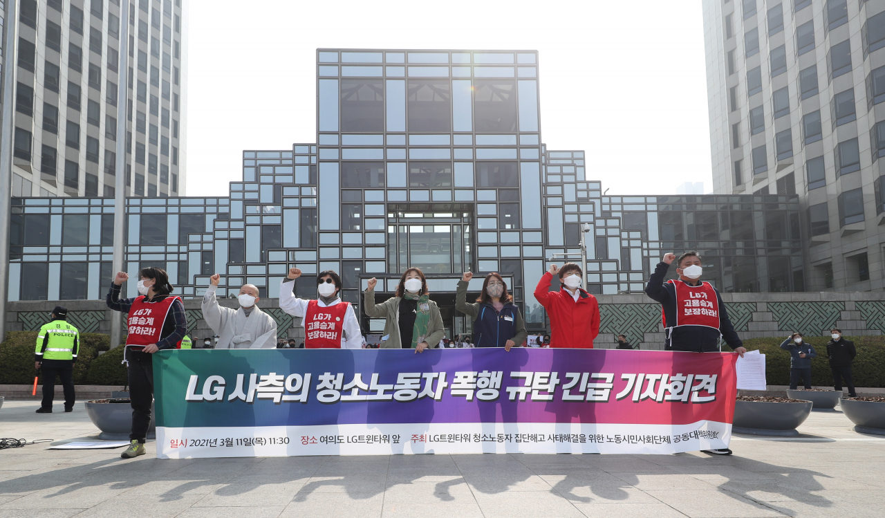 전국민주노동조합총연맹 공공운수노조 관계자들이 지난 11일 서울 영등포구 LG트윈타워 앞에서 열린 LG트윈타워 청소노동자 폭행 규탄 기자회견에서 구호를 외치고 있다. [연합]