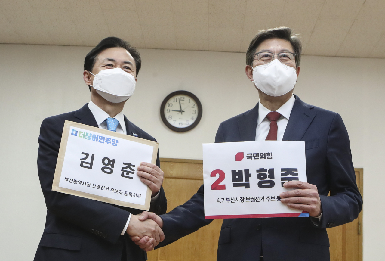 4·7 부산시장 보궐선거에 도전하는 김영춘 더불어민주당 후보(왼쪽)와 박형준 국민의힘 후보가 지난 18일 오전 부산 연제구 부산시 선거관리 위원회에서 보궐선거 부산시장 후보 등록을 하며 만나 악수를 하고 있다. [연합]