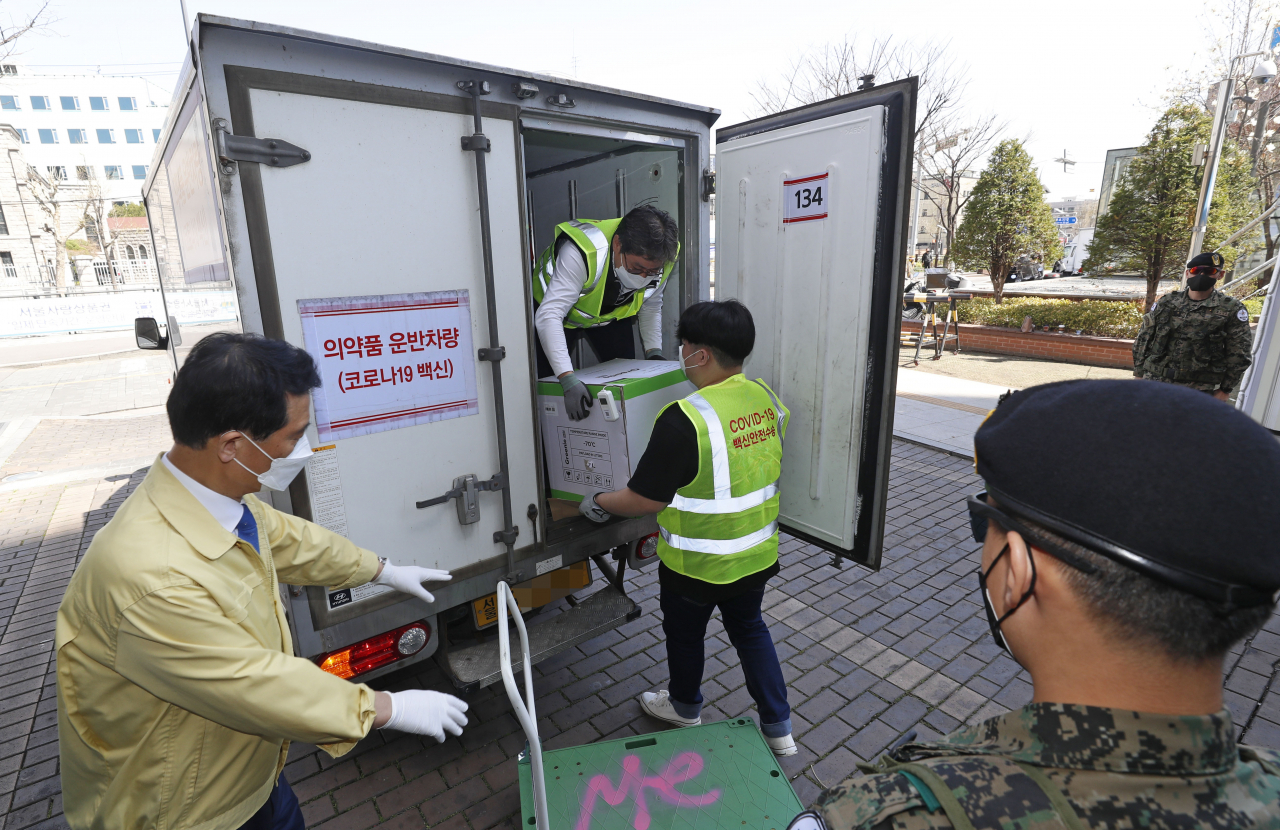 30일 오후 서울 성북구청에 마련된 예방접종센터에 만 75세 이상 고령층 접종에 사용될 신종 코로나바이러스 감염증(코로나19) 예방 백신(화이자)이 도착해 관계자들이 백신이 든 상자를 옮기고 있다. [연합]