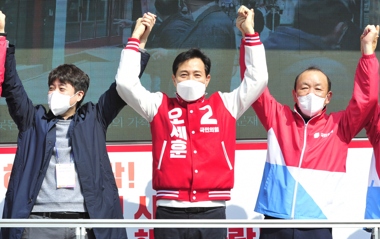 오세훈 국민의힘 서울시장 후보(가운데)가 4·7 재보선 공식 선거운동 시작일인 25일 오전 서울 서대문구 유진상가 앞에서 선거유세를 마친 후 이준석 전 미래통합당 최고위원(왼쪽), 송주범 당원협의회운영위원장과 손을 맞잡아 들어보이고 있다. [연합]