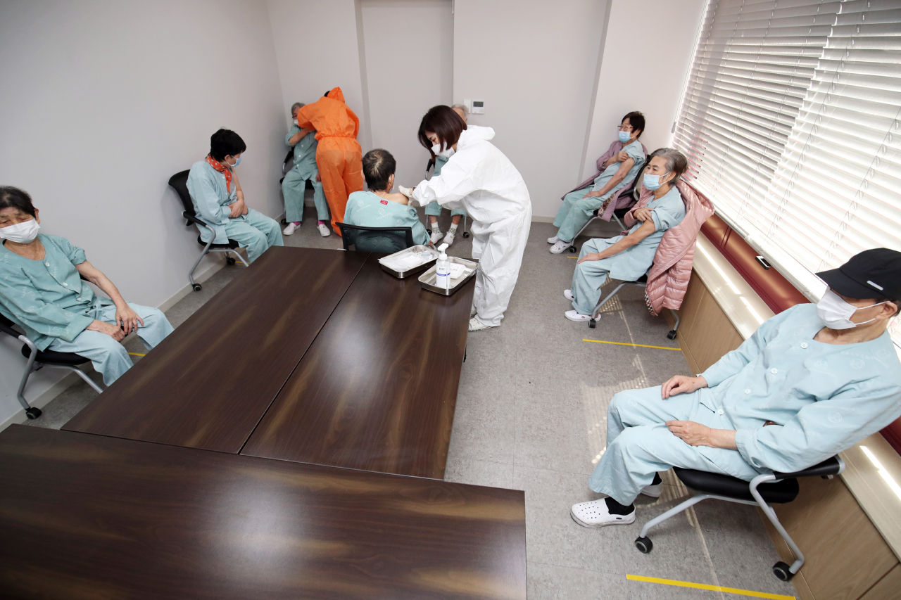 COVID-19 vaccines from AstraZeneca are given to patients at an elderly care facility in Gwangju on March 23. (Yonhap)