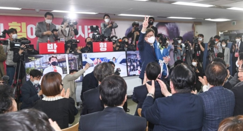 박형준 부산시장이 7일 오후 부산진구 선거사무소에서 꽃다발을 받고 환호하고 있다.[연합]