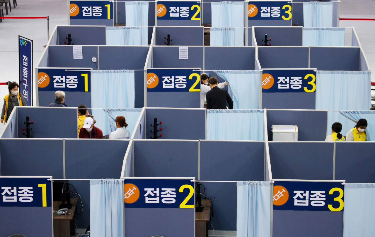지난 23일 대구 수성구 육상진흥센터에 설치된 수성구 코로나19 예방접종센터에서 시민들이 백신접종을 하고 있다. 수성구 접종센터는 전날부터 75세 이상을 대상으로 화이자 백신접종을 시작했다. [연합]