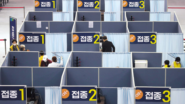 지난 23일 대구 수성구 육상진흥센터에 설치된 수성구 코로나19 예방접종센터에서 시민들이 백신접종을 하고 있다. 수성구 접종센터는 전날부터 75세 이상을 대상으로 화이자 백신접종을 시작했다. [연합]