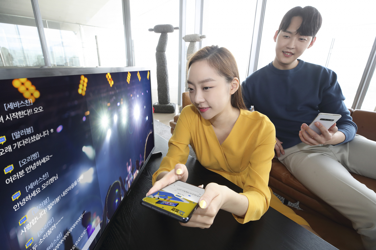 KT가 같은 TV프로그램을 시청 중인 사람들과 스마트폰으로 실시간 소통하는 ‘TV채팅’ 서비스를 선보인다고 27일 밝혔다. 사진은 KT 고객들이 올레tv를 보면서 실시간으로 채팅을 진행하고 있는 모습. [KT 제공]