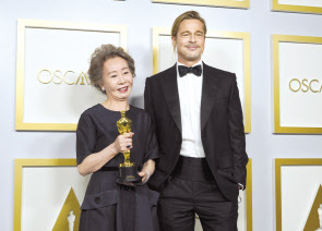 여우조연상 트로피를 든 윤여정이 시상자로 나서 직접 상을 건넨 할리우드 대표배우 브래드 피트와 나란히 서서 포즈를 취하고 있다. [EPA]