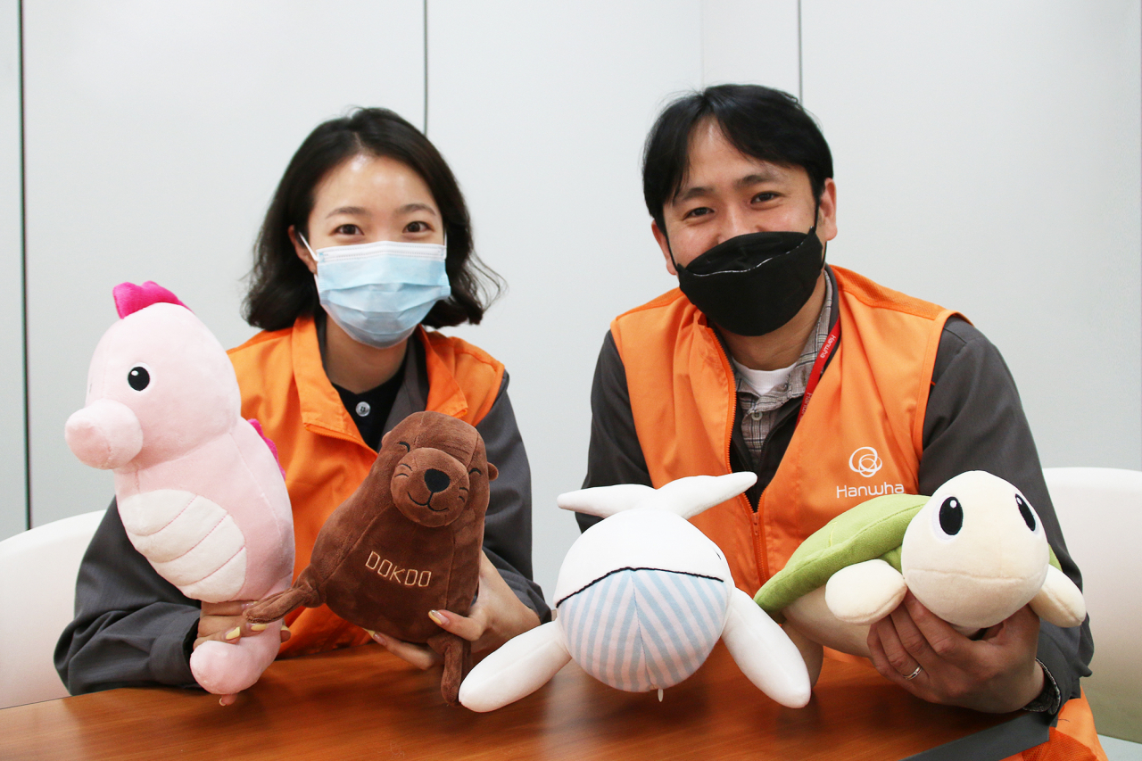 ‘바다를 살리는 업사이클링 인형 만들기’ 행사에 참가한한화에어로스페이스 임직원들이 직접 만든 인형을 들고 있다. [한화에어로스페이즈 제공]
