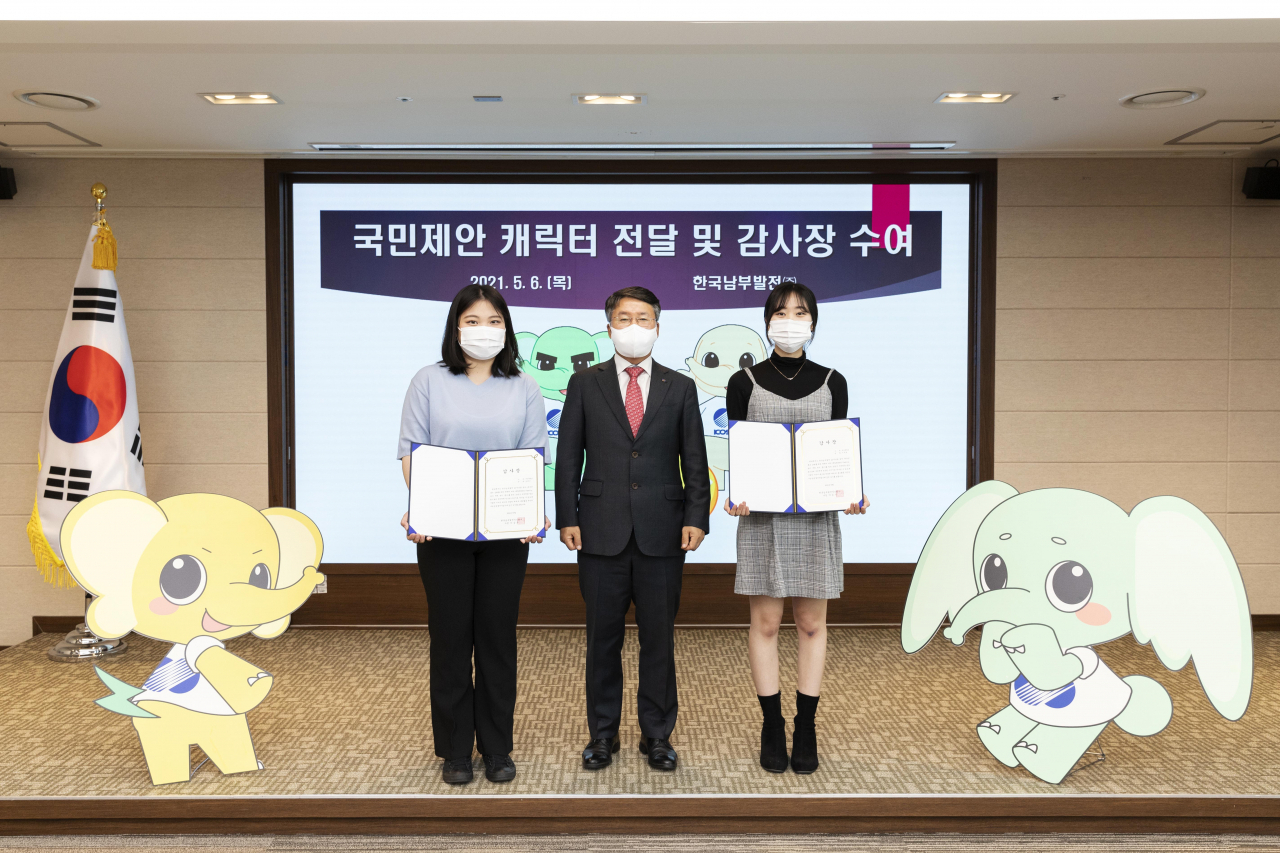 한국남부발전 이승우 사장(사진 가운데)이 캐릭터 ‘에코패밀리(EKO Family)’를 창작 및 양도해준 남예민, 이주원 학생에게 감사장 전달 후 함께 기념촬영을 하고 있다. [남부발전 제공]