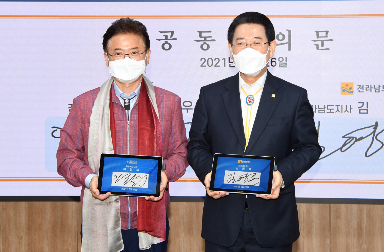 이철우 경북지사(왼쪽)와 김영록 전남지사가 26일 전남도청에서 상생협력 등을 위한 공동합의문에 서명한 뒤 기념촬영을 하고 있다.[경북도 제공]