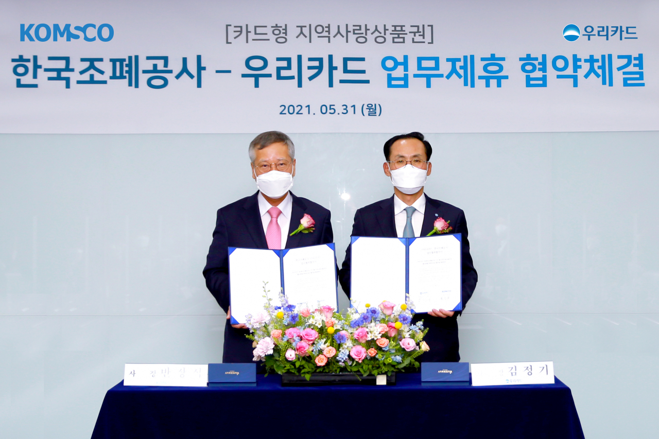 반장식(왼쪽) 한국조폐공사 사장과 김정기 우리카드 사장이 31일 우리카드 본사에서 카드형 지역사랑상품권의 원활한 서비스 제공을 위한 업무협약을 체결한 후 기념촬영을 하고 있다. [한국조폐공사 제공]