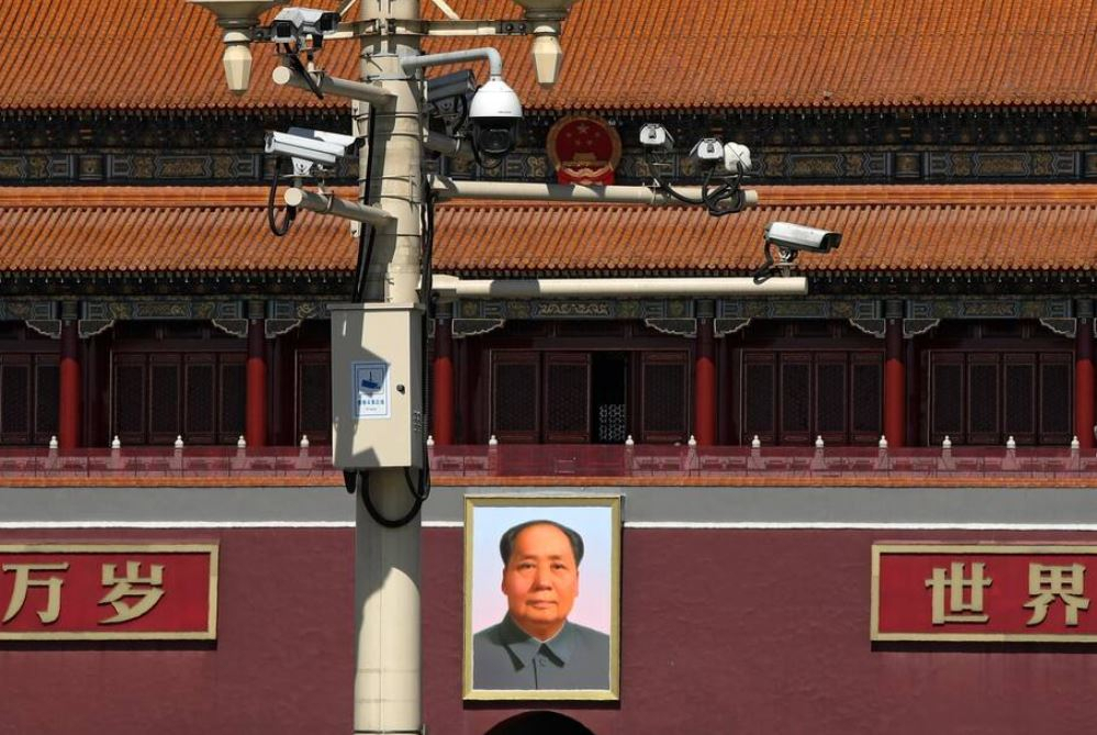 중국 베이징 시내의 신호등에 감시 카메라가 설치돼 있다. 천안문에 걸린 마오쩌둥(毛澤東)의 초상화도 보인다. [AP]
