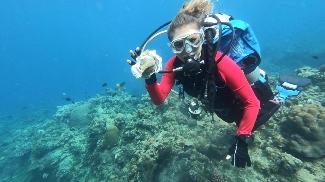 Resort owner and dive instructor Carmela Sevilla shows a plastic trash she recovered underwater during a scuba diving activity in Bauan, Batangas, Philippines, Sunday. (Reuters-Yonhap)