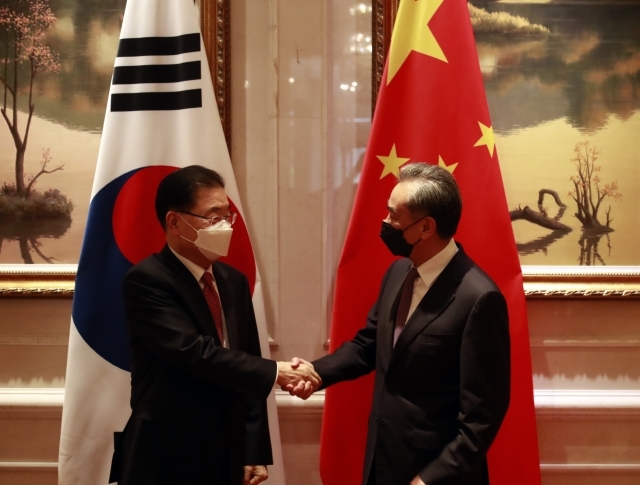 South Korean Foreign Minister Chung Eui-yong (left) and Chinese Foreign Minister Wang Yi shake hands before their talks at a hotel in Xiamen in southeastern China in April. (Yonhap)