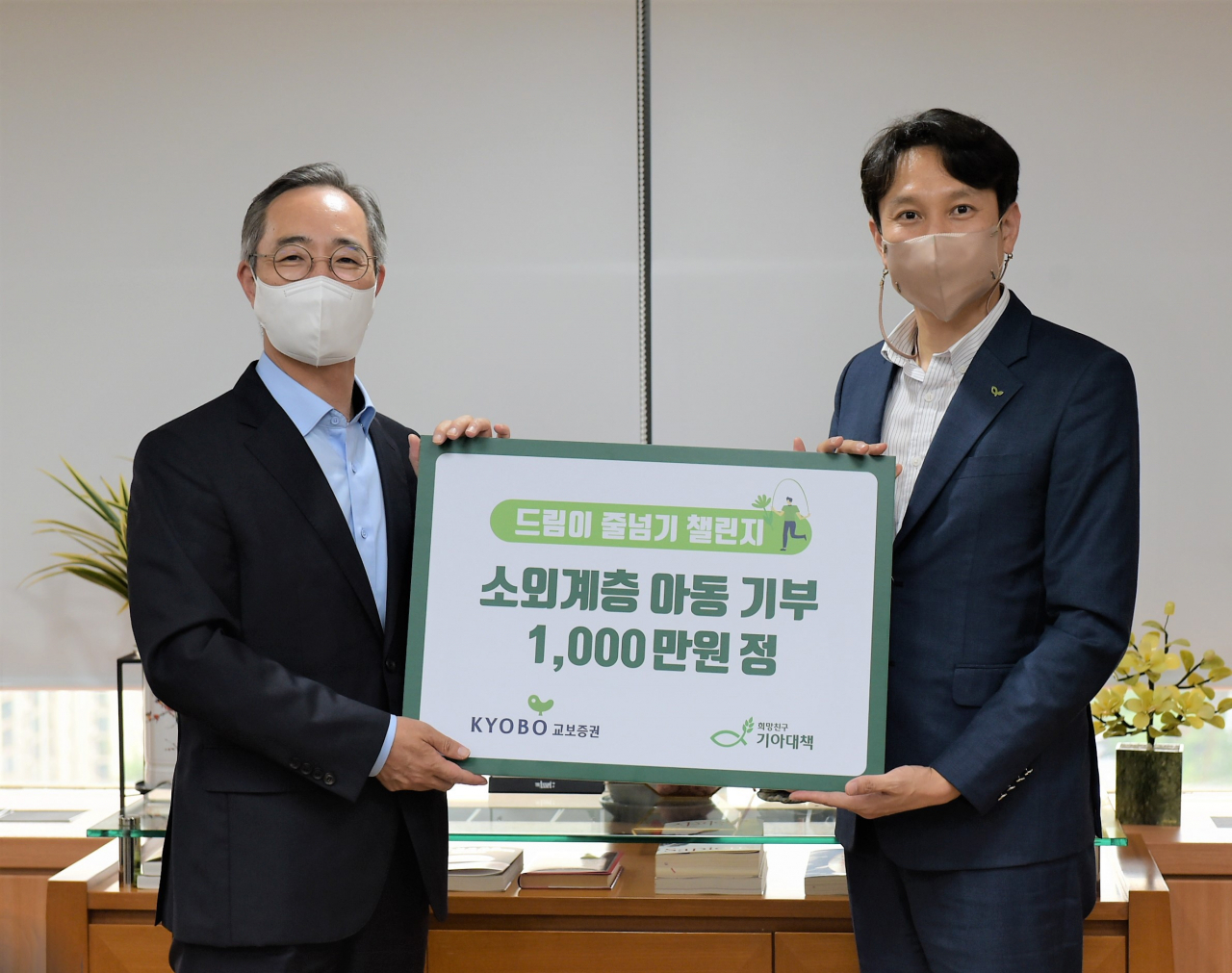 이석기 교보증권 대표이사(왼쪽)와 정규상 기아대책 본부장이 10일 여의도 교보증권 본사에서 기부금 전달식을 갖고 기념촬영을 하고 있다.[교보증권 제공]