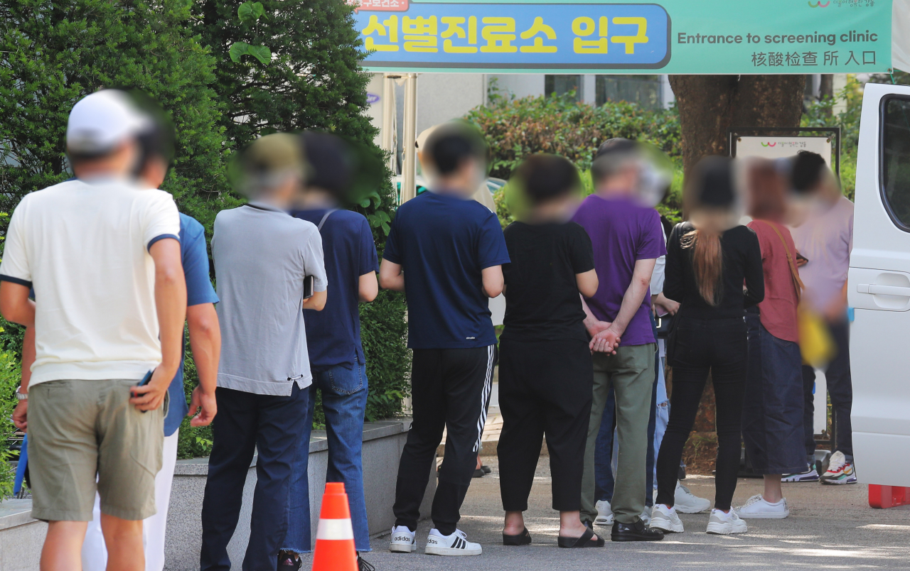 12일 오전 서울 강동구 보건소 선별진료소에서 시민들이 코로나19 검사를 받기 위해 대기하고 있다. 중앙방역대책본부는 이날 0시 기준으로 신규 확진자가 565명 늘어 누적 14만7천422명이라고 밝혔다. [연합]