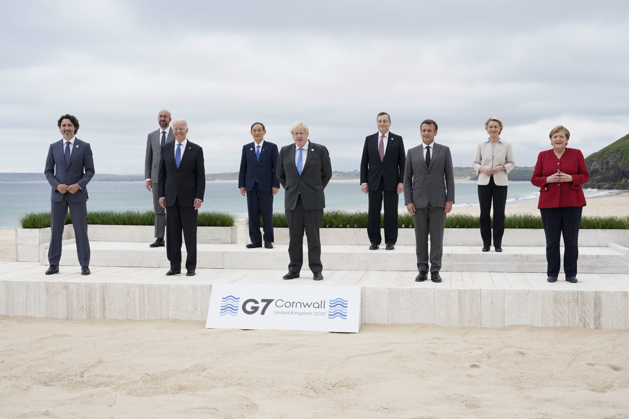 Leaders of the G7 pose for a group photo on overlooking the beach at the Carbis Bay Hotel in Carbis Bay, Cornwall, England, Friday. (Yonhap)