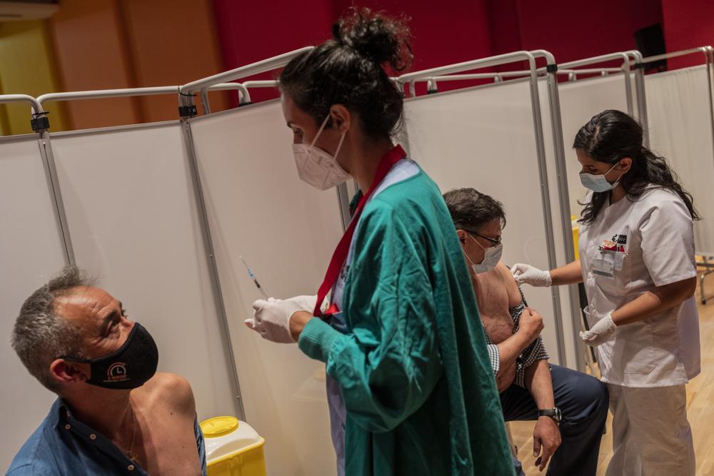 In this May 13, 2021, file photo, men are administered the Pfizer COVID-19 vaccine at the Severo Ochoa Hospital in Leganes, outskirts of Madrid, Spain. Countries across Europe are scrambling to accelerate coronavirus vaccinations to outpace the spread of the delta variant in a high-stakes race to prevent hospital wards from filling up again with patients fighting for their lives. (AP)