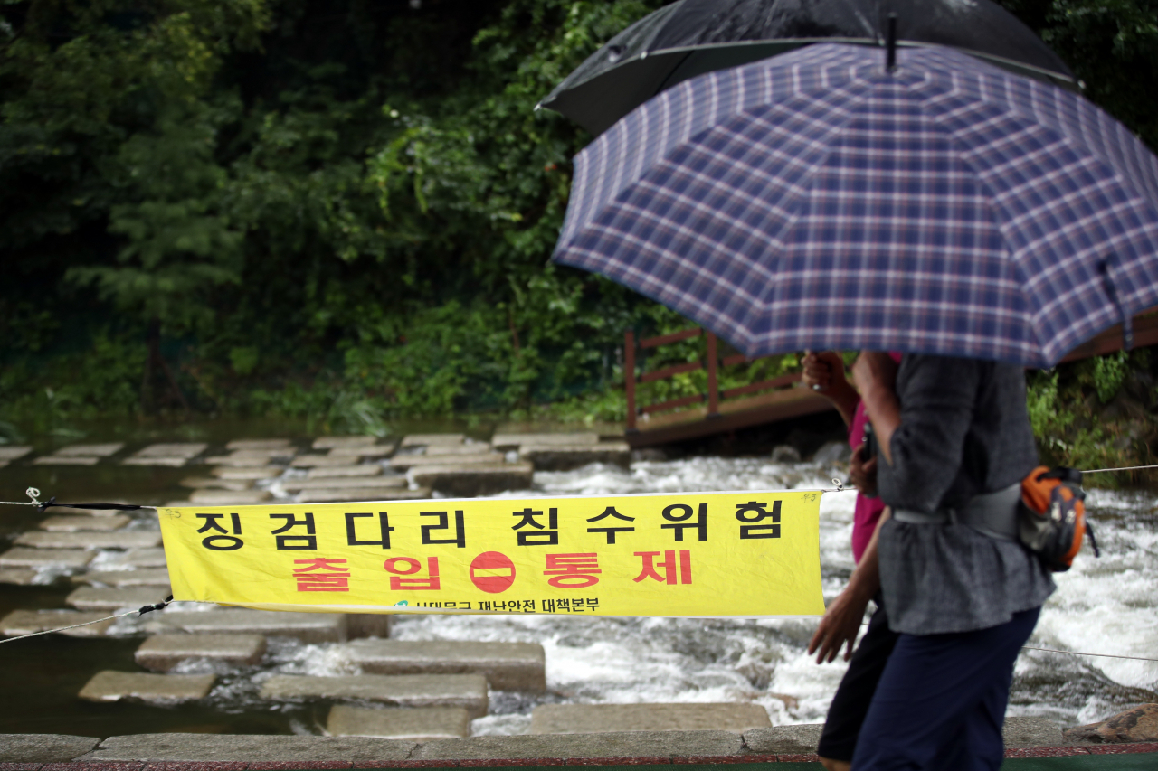 비가 내린 4일 오전 우산을 쓴 시민들이 서울 홍제천변에서 산책하고 있다. 이날은 장맛비가 낮까지 내리다가 제주를 제외한 전국 대부분 지역에서 그칠 것으로 예보됐다. [연합]