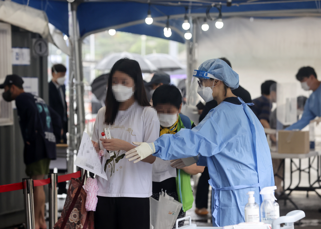 국내 신종 코로나바이러스 감염증(코로나19) 확산세가 지속하면서 신규 확진자 수 700명대 중반을 기록한 4일 오전 서울역에 설치된 임시선별검사소에서 시민들이 검사를 받기 위해 기다리고 있다. [연합]
