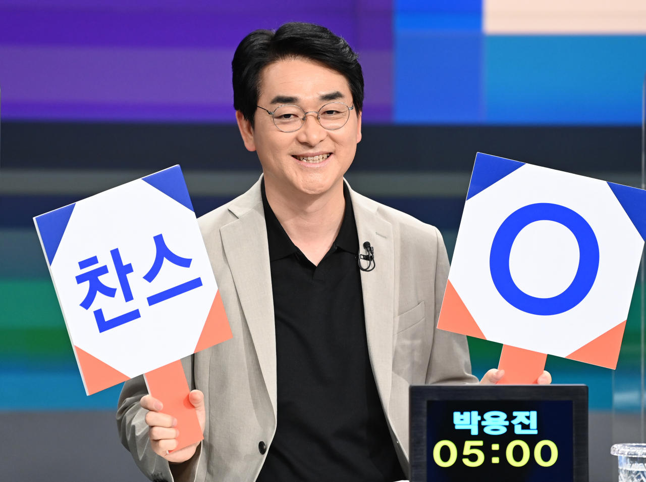 더불어민주당 대선 예비후보자인 박용진 의원이 지난 5일 서울 마포구 JTBC 스튜디오에서 합동 TV토론에서 '찬스, OX' 퀴즈판을 들고 미소짓고 있다. [연합]