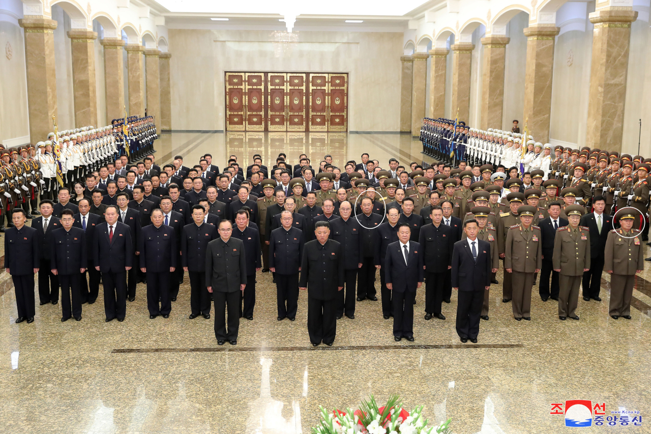 North Korean leader Kim Jong-un (second from left, front row stands alongside members of the Presidium of the Politburo of the Workers' Party of Korea, as he visits the Kumsusan Palace of the Sun in Pyongyang on Thursday, to pay tribute to his grandfather and North Korea's founder, Kim Il-sung, on the occasion of the 27th anniversary of the former leader's death. Ri Pyong-chol (third row, in circle), vice chairman of the Central Committee of the Workers' Party, is seen on the third row in an indication that he might have been removed from the Presidium at its meeting late last month. (KCNA-Yonhap)