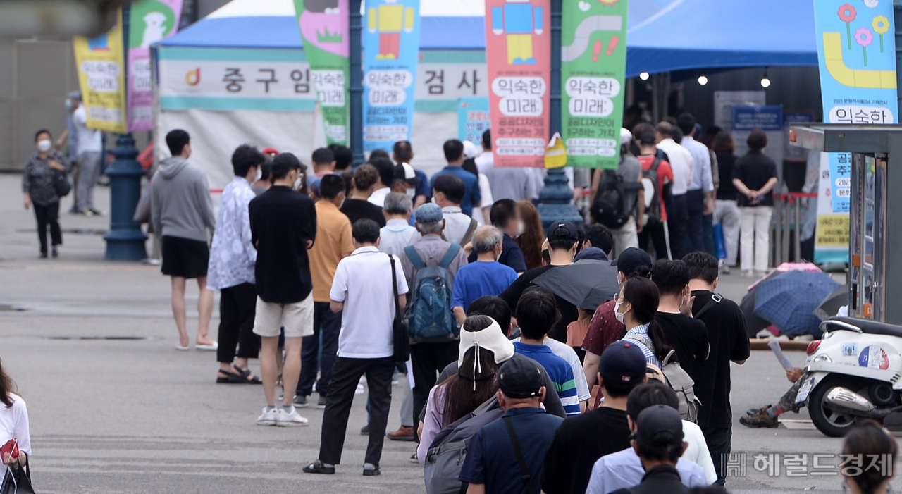 [헤럴드경제=이상섭 기자] 코로나19 확진자수가 엿새째 1000명대를 넘긴 가운데 12일 오전 서울 중구 서울역 인근에 마련된 임시선별진료소에서 시민들이 검사를 받기 위해 길게 줄을 서있다.