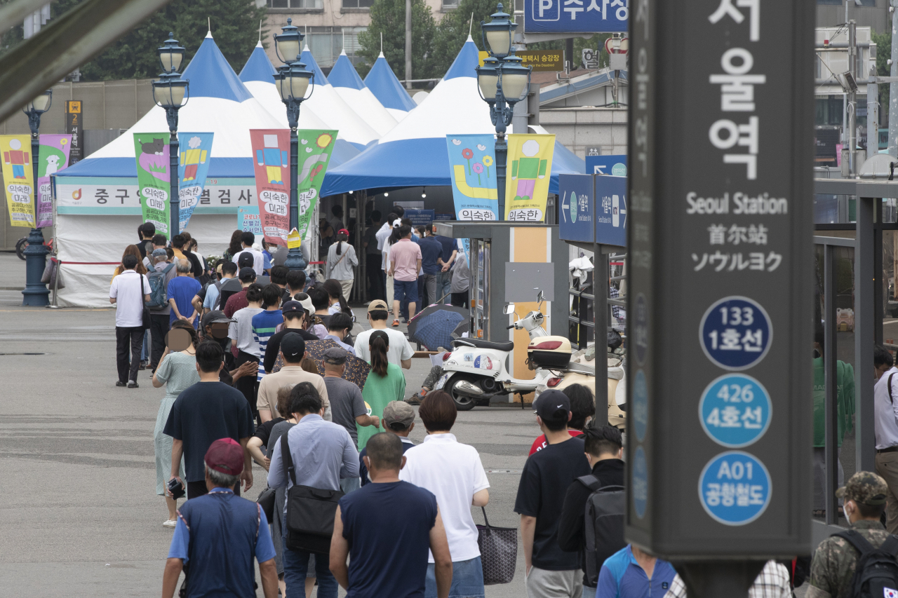 12일 서울시 중구 서울역 광장에 설치된 임시선별검사소에서 신종 코로나바이러스 감염증(코로나19) 검사를 받기 위해 시민들이 줄지어 있다. 연합뉴스