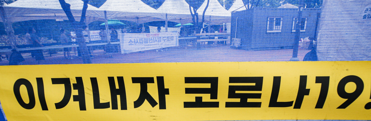 신종 코로나바이러스 감염증(코로나19) 신규 확진자가 1주일째 1천 명 이상 기록 중인 13일 오후 서울 마포구 홍대 거리 내 홍익문화공원에 설치된 마포구 임시선별검사소에서 코로나19 검사를 받으려는 시민들이 더위 속에 대기하고 있다. [연합뉴스]