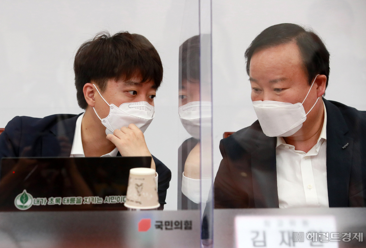 이준석(왼쪽) 국민의힘 대표와 김재원 최고위원이 22일 오전 서울 여의도 국회에서 열린 최고위원회의에서 대화하고 있다. [이상섭 기자/babtong@heraldcorp.com]