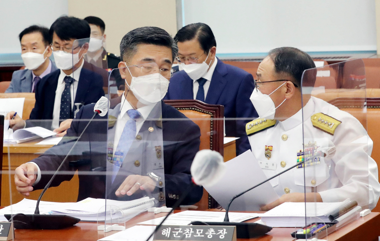 국방부는 26일 청해부대 집단감염 사태를 계기로 코로나19 백신 미접종자를 해외파병 선발에서 제한하는 방안을 검토중이라고 밝혔다. 서욱 국방부 장관(왼쪽)과 부석종 해군참모총장이 이날 오전 국회 국방위원회 전체회의에서 대화를 나누고 있다. [연합]