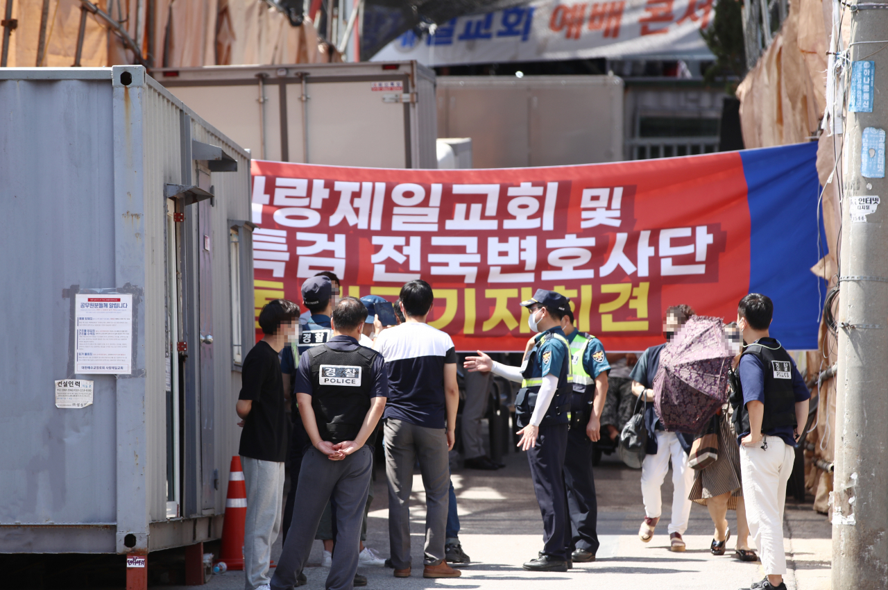 종교시설의 대면 활동을 금지한 사회적 거리두기 4단계 시행 후 두 번째 일요일인 25일 오후 서울 성북구 사랑제일교회 앞에서 서울시, 성북구청, 경찰 관계자들이 현장 대면 예배 관련 방역수칙 현장점검 채증을 하고 있다. [연합]