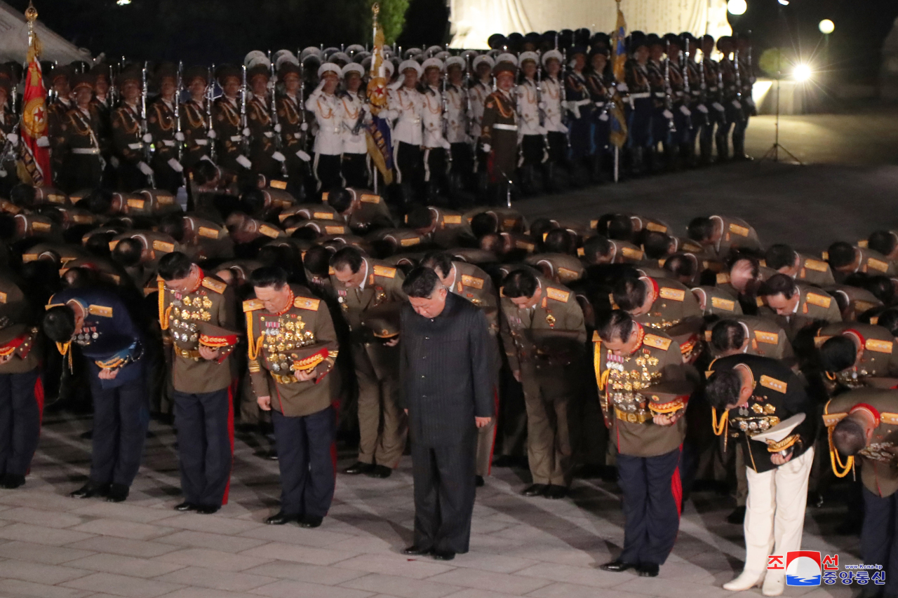 North Korean leader Kim Jong-un (center) pays respects to fallen soldiers from the 1950-53 Korean War during his visit to the Fatherland Liberation War Martyr's Cemetery in Pyongyang on Tuesday. (KCNA-Yonhap)
