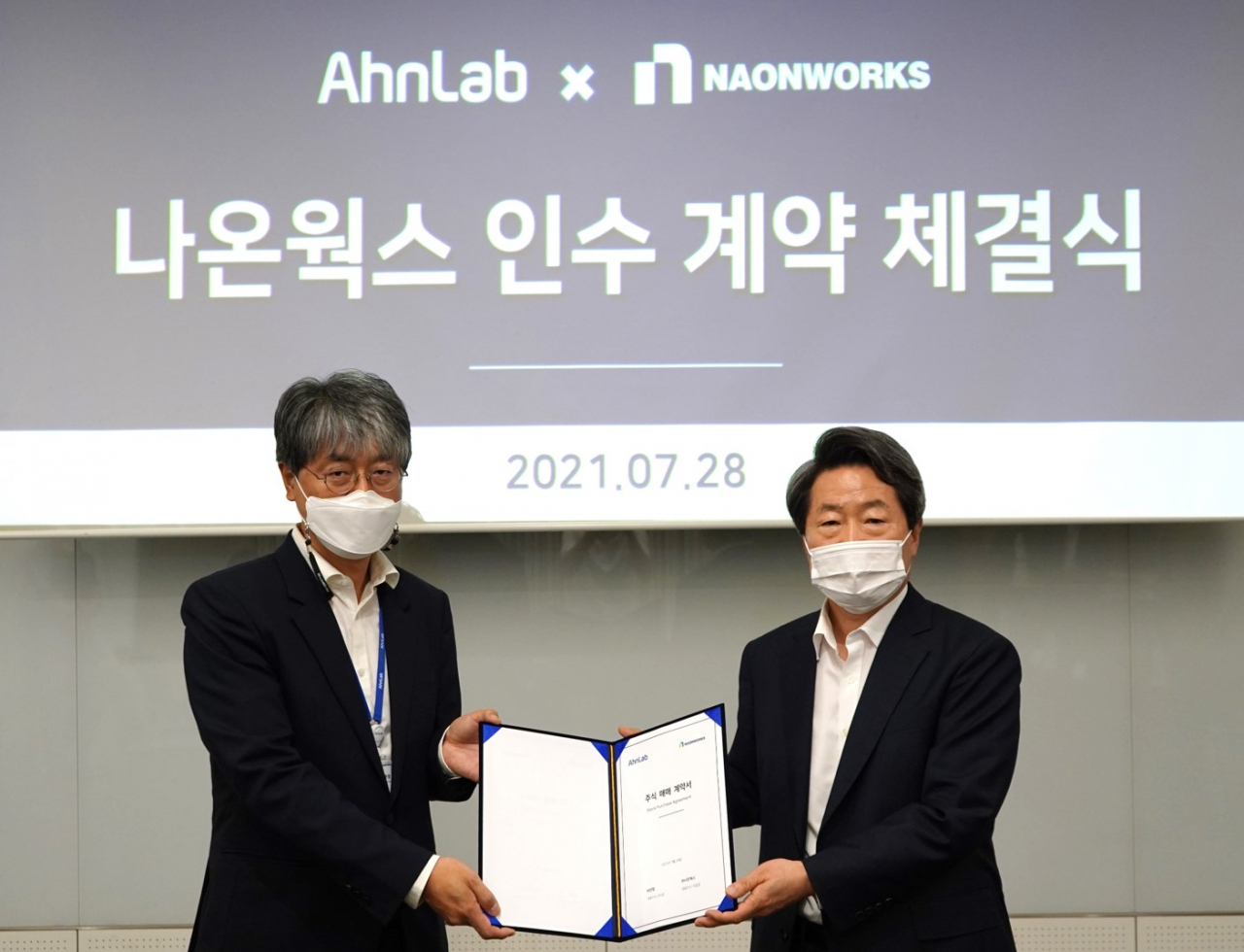 안랩 강석균 대표(우측)와 나온웍스 이준경 대표(좌측)가 인수 계약 체결 기념 촬영을 하고 있다. [안랩 제공]