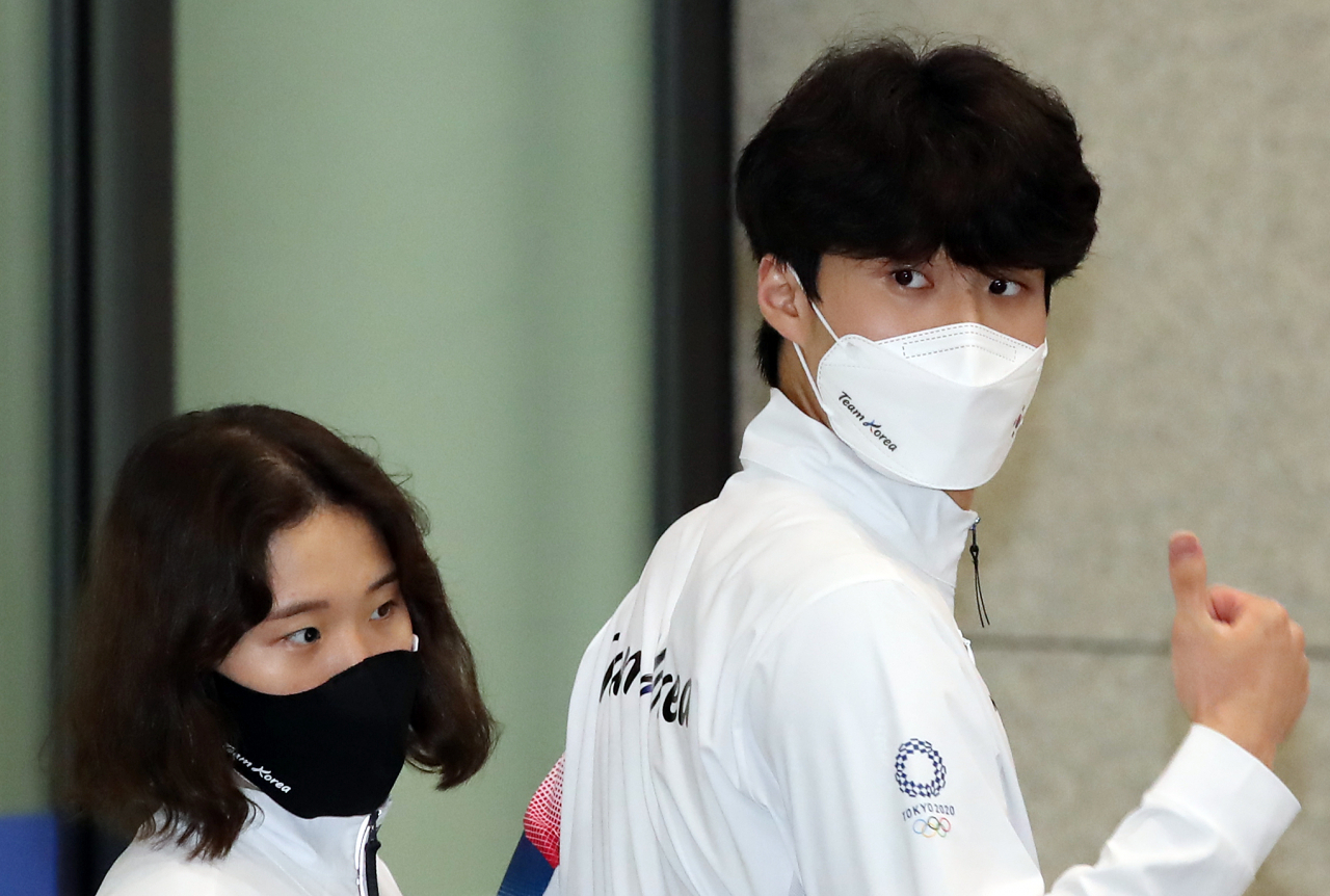 2020 도쿄올림픽을 마치고 귀국한 수영의 황선우가 1일 오후 영종도 인천국제공항을 통해 귀국하며 엄지 손가락을 들어보이고 있다. 왼쪽은 한다경. [연합]