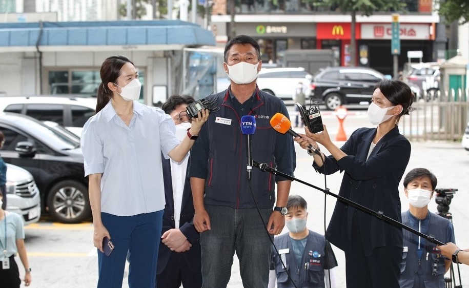 Yang Kyung-soo (C), chief of the Korean Confederation of Trade Unions, speaks to reporters before entering Jongno Police Station in Seoul on Aug. 4, 2021. (Yonhap)