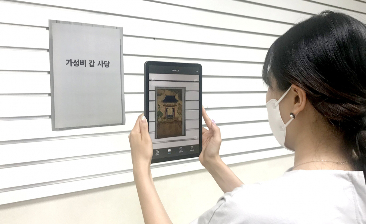 빈 액자를 태블릿PC로 찍으면 그림이 나타난다.