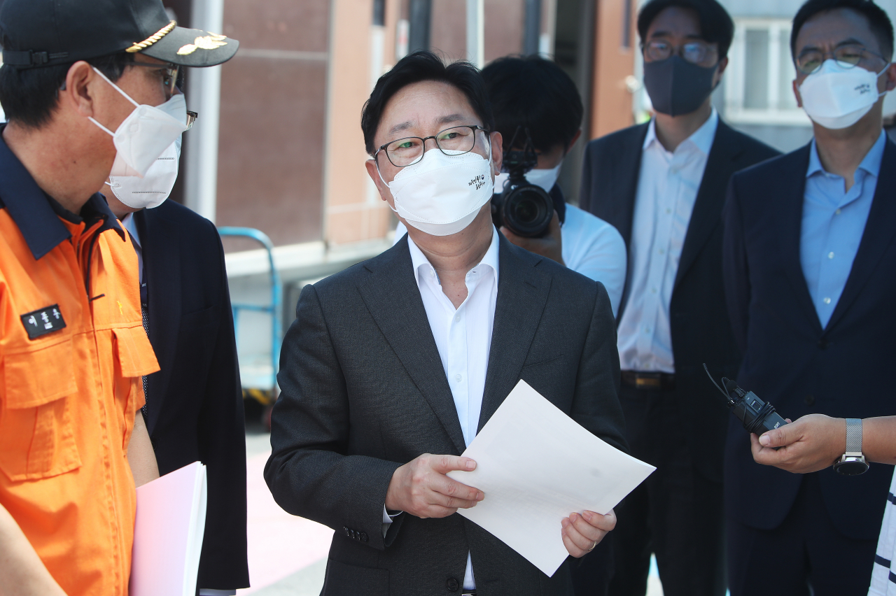 박범계 법무부 장관이 18일 오후 경기도 이천시 쿠팡 덕평물류센터 화재현장을 찾아 설명을 듣고 있다. [연합]