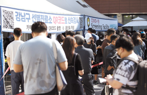 국내 신종 코로나바이러스 감염증(코로나19) 확산세가 지속하면서 신규 확진자 수가 2000명대를 기록한 20일 오전 서울 강남구보건소에 마련된 선별진료소를 찾은 시민들이 코로나19 선별검사를 받기 위해 줄을 서 있다. 중앙방역대책본부는 이날 0시 기준 신규 확진자가 2052명 늘어 누적 23만2859명이라고 밝혔다. [연합]