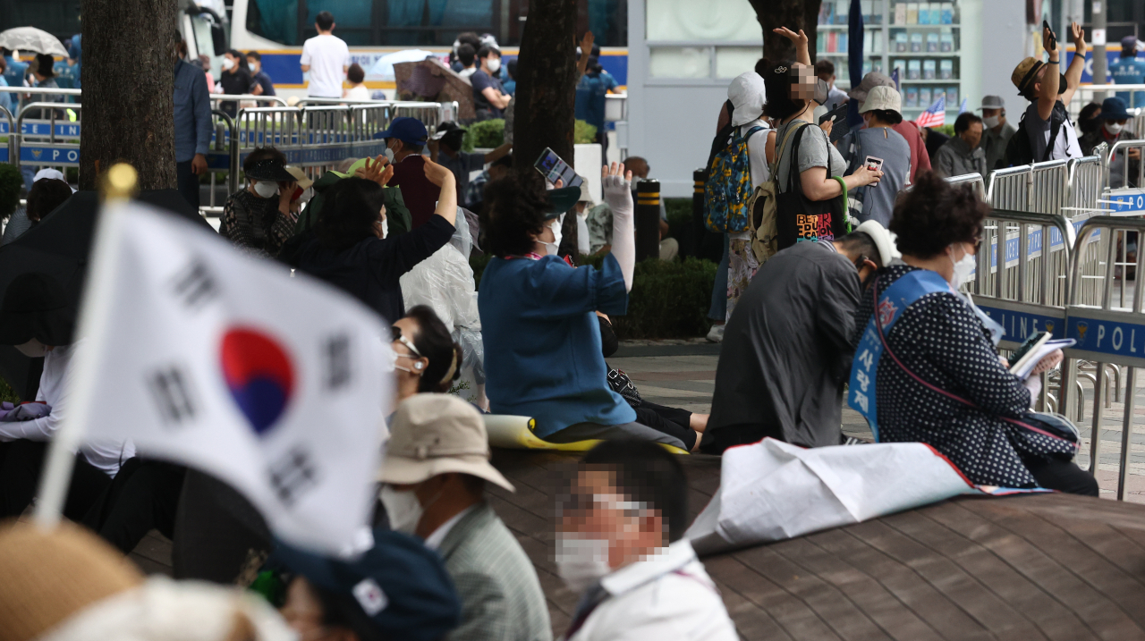 관할 구청으로부터 시설 폐쇄 결정을 받은 서울 성북구 사랑제일교회 신자들이 22일 서울 광화문 동화면세점 앞에서 현장 예배를 하고 있다. [연합]
