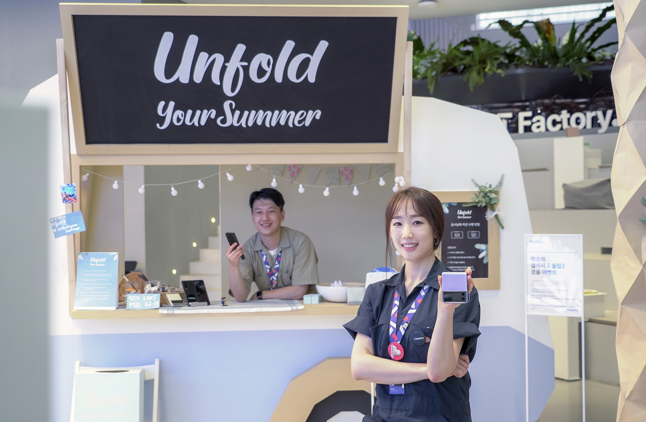 SK텔레콤 직원들이 홍대 정보통신기술(ICT)멀티플렉스 T팩토리에 설치된 폴더블 체험존을 소개하고 있다. [SK텔레콤 제공]