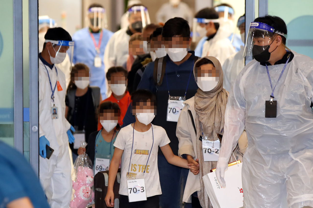 The second group of Afghan evacuees arrives at Incheon Airport, west of Seoul, on Friday, as South Korea completes an operation to evacuate local co-workers of the country's embassy and other facilities in the war-torn nation and their families after the Taliban's seizure of power. (Yonhap)